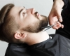 man getting his beard trimmed
